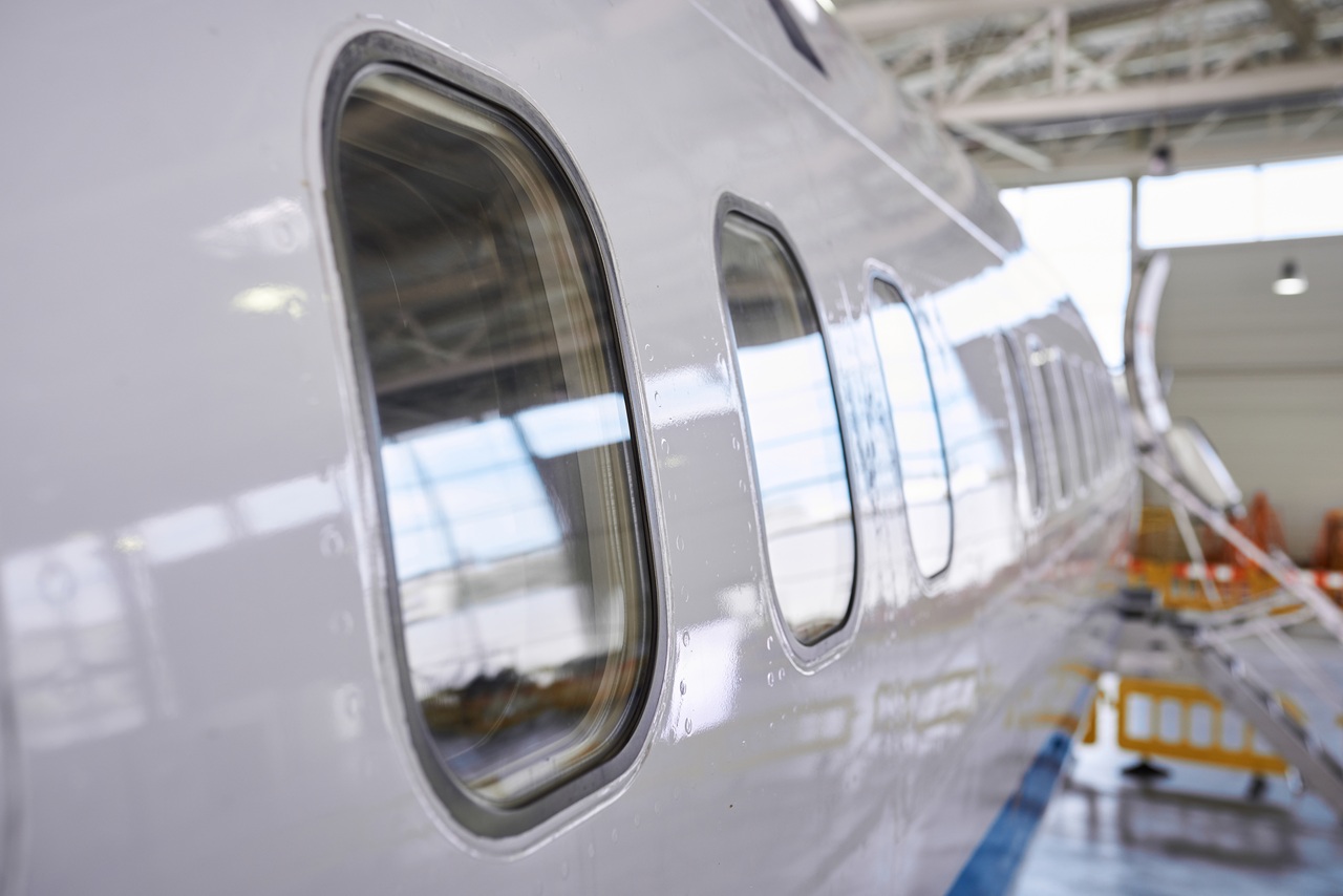 Closeup view on illuminators of passenger aircraft standing on parking place at airport hangar. nobody